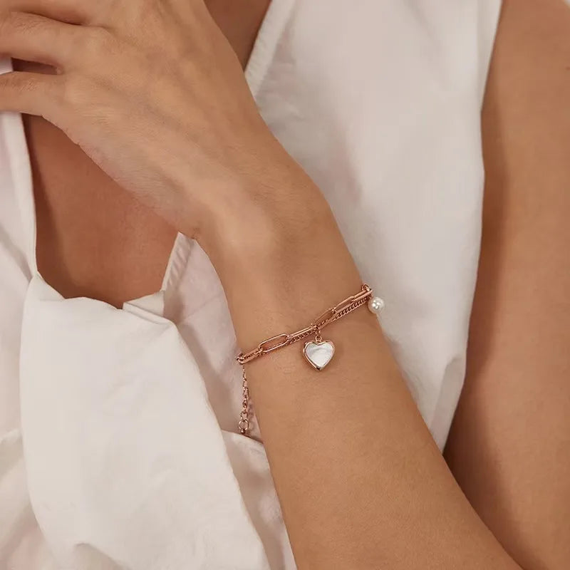 Gold layered bracelet with heart and faux pearl charm